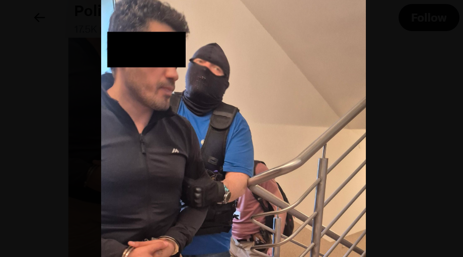 Силовик ведет Эльнура А. Скриншот фото полиции Люблина от 20.06.26, https://x.com/PolicjaLubelska/status/2068301027225292818/photo/1.