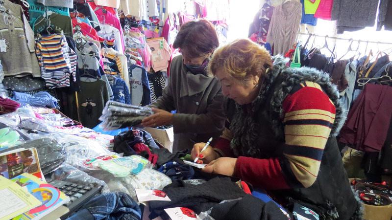 Сотрудница дома-интерната Григорян Шогер (слева) выбирает  для детей необходимое.